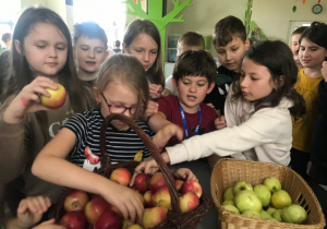 Dzieci częstują się pysznym i zdrowym jabłuszkiem